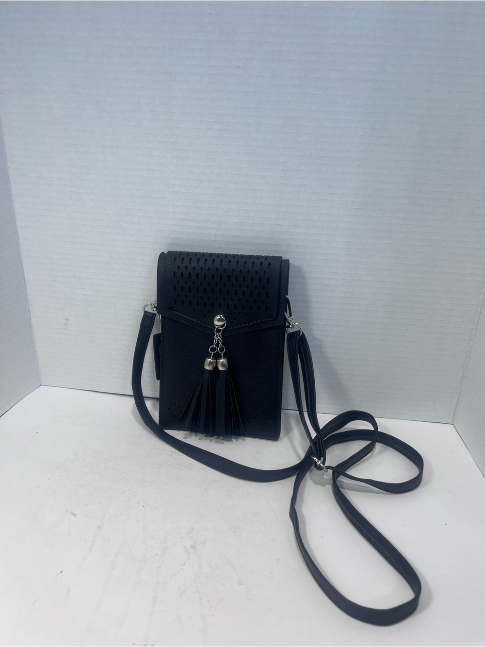 Compact Black Crossbody Bag with Tassel Detail
